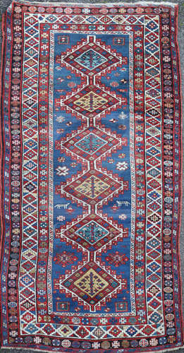 A Kazak Caucasian runner, woven with a central row of six large lozenges, within a multiple