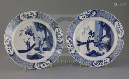 A pair of Chinese blue and white 'ladies' plates, Kangxi period, each painted with two ladies in a