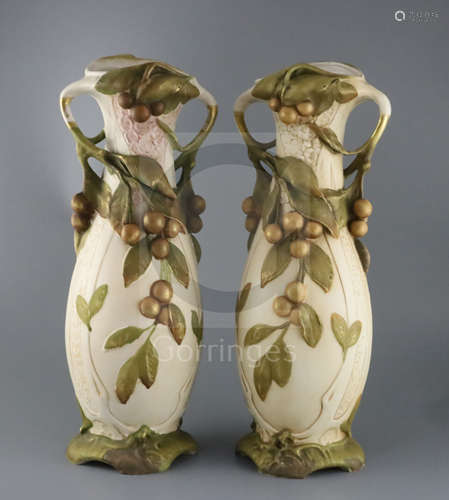 A pair of tall Royal Dux Art Nouveau two handled vases, early 20th century, each modelled with