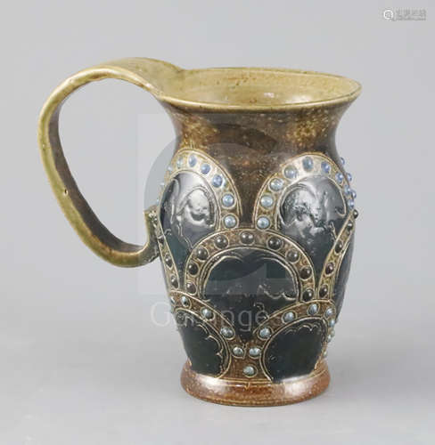 A Martin Brothers mug, late 19th century, with arched embossed decoration to the baluster shaped