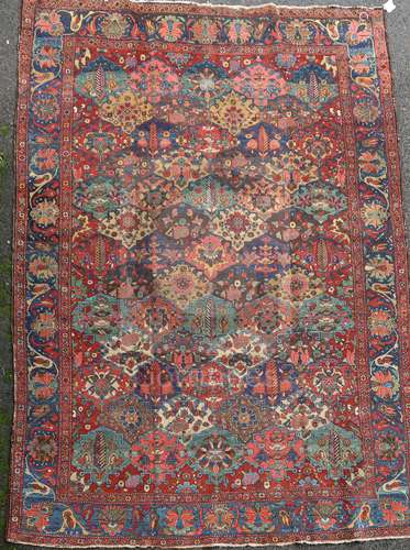 A Bakhtiari red ground carpet, with field of geometric flower heads and foliate border, 10ft 3 x