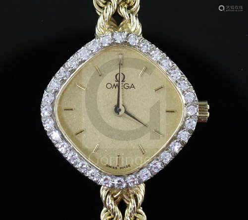 A lady's modern 14ct gold and diamond set Omega quartz dress wrist watch, the shaped dial with baton