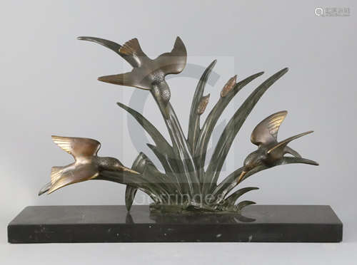 G. Limousin. A French Art Deco bronze group of three kingfishers flying amongst bulrushes, on