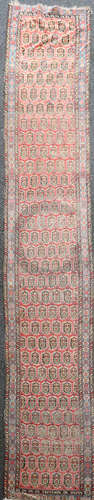 An antique Fereghan red ground runner, with field of geometric pears and a three row border, 16ft