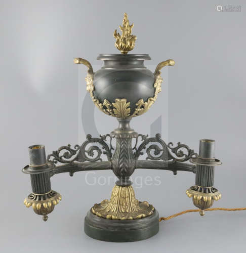 A William IV table top bronze double light Colza lamp, the burners held by cast dog heads on each