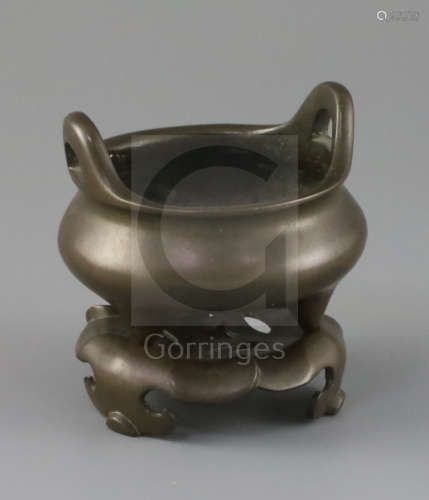 A Chinese bronze tripod censer and stand, Xuande mark but later Qing dynasty, the pierced stand with