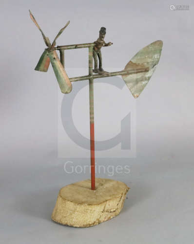 An American? painted wrought iron whirligig, on tree trunk plinth, H.39in.