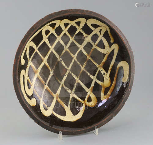 An English slipware circular baking dish, 18th / 19th century, decorated with a lattice design in