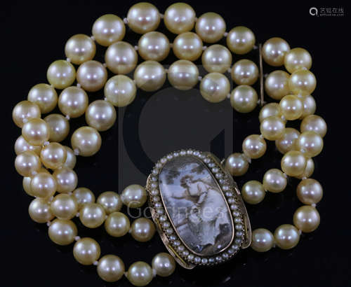 A triple strand cultured bracelet, now with a Regency gold mounted oval panel mourning clasp,