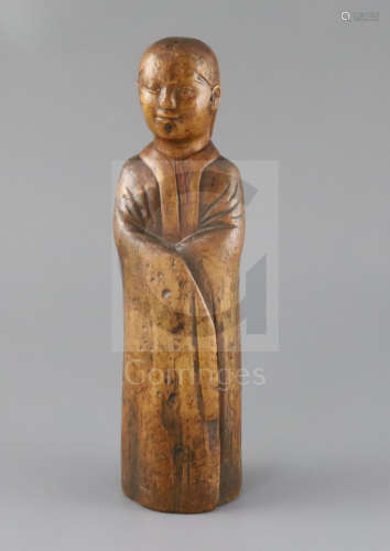 A Chinese wood figure of a sage or scholar, Qing dynasty, wearing long robes and with plaited