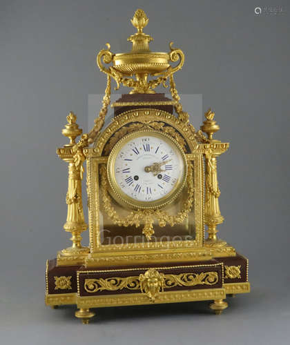 A 19th century French Louis XVI style ormolu and red marble mantel clock, the architectural case