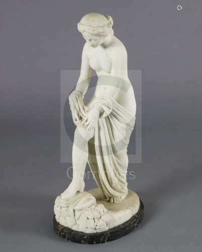 A Victorian style carved white marble figure of a woman pulling on her stocking, on variegated black