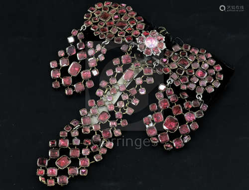 A late 18th century French pinchbeck and shaped cut garnet set drop hair ornament, with black ribbon