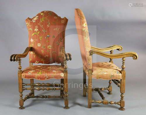 A pair of 19th century French 17th century style carved walnut high back armchairs, with floral