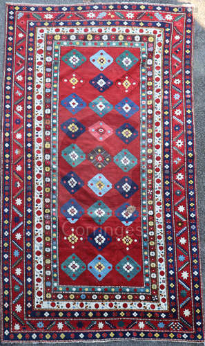 A Lambalo Kazak Caucasian small carpet, the red field woven with three rows of stylised floral