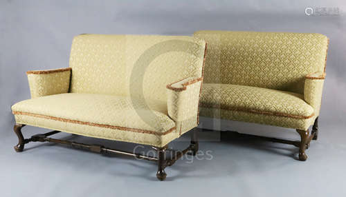 A Queen Anne upholstered scroll arm sofa and a matching reproduction sofa, with cabriole legs,