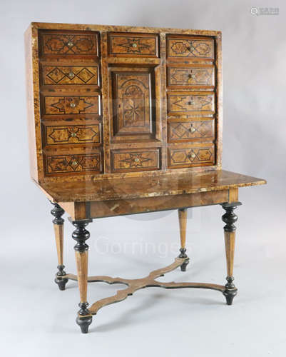 A Louis XIV inlaid walnut cabinet on stand, the upper section with twelve short drawers