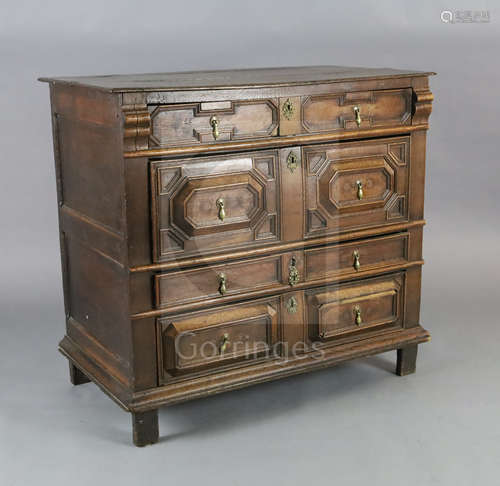 A late 17th century oak chest, of four long drawers with geometric moulded decoration, on stile