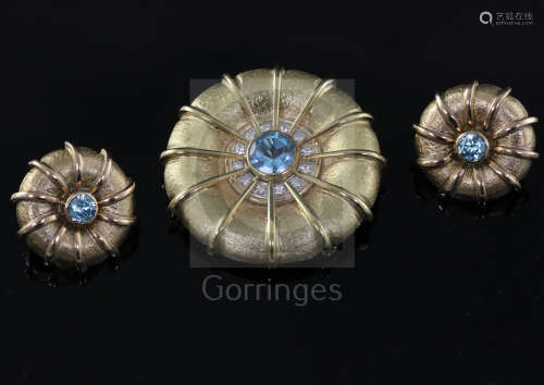 A late 1990's 9ct gold, blue zircon and diamond set circular pendant brooch, and a similar pair of