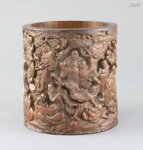 A Chinese bamboo 'eighteen luohan' brush pot, late Qing dynasty, the exterior carved in high