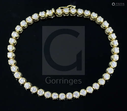 An Italian 18ct gold and diamond line bracelet, set with forty two claw set round cut diamonds, 18.