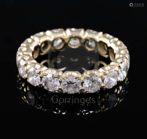 A gold and diamond full eternity ring, set with sixteen round cut diamonds, with a total approximate