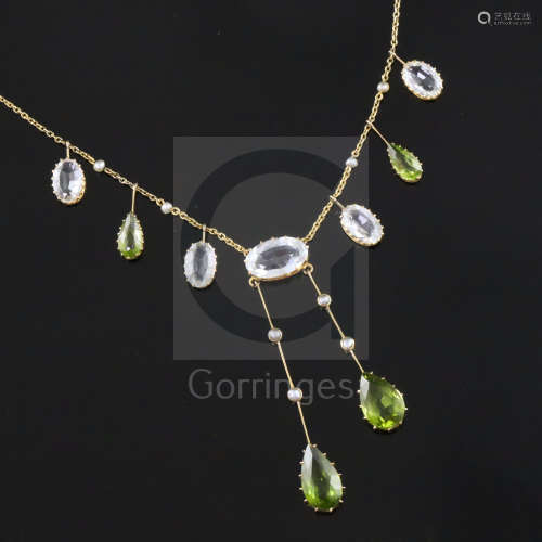 An Edwardian 9ct gold, peridot, aquamarine and split pearl drop pendant necklace, set with five
