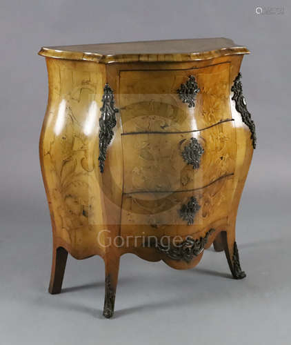 A late 19th century Dutch walnut and marquetry bombe commode, fitted three long drawers and inlaid