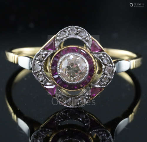 A 1920's gold and platinum, ruby and diamond set cluster ring, the pierced setting with central