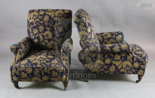 A pair of Victorian club armchairs, with blue floral scroll upholstery, on turned mahogany legs