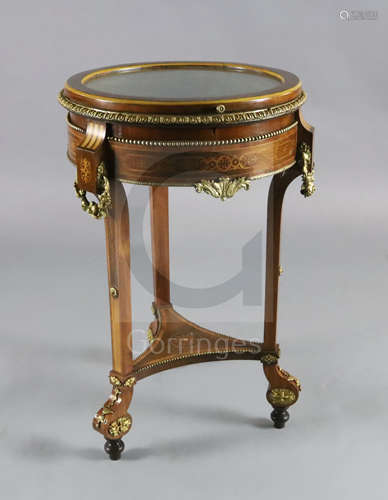 An early 20th century French mahogany and marquetry bijouterie table, with glazed circular drum