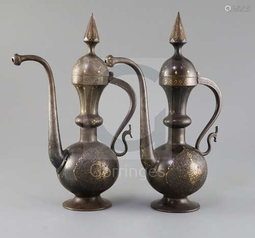 A pair of 19th century Qajar gold inlaid iron rosewater sprinklers, with spire finials and