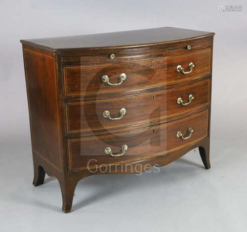 A George III mahogany bowfront chest, with chevron strung top, brushing slide and three graduated