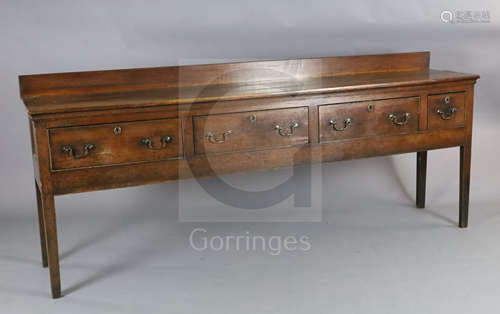 A George III oak dresser base, with planked top and four drawers, on squared tapered legs, W.7ft