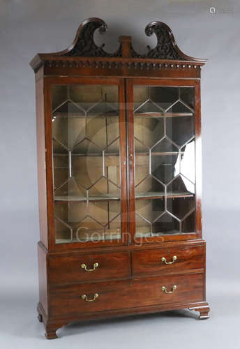 A George III mahogany display cabinet, with blind fret carved swan neck pediment and two astragal