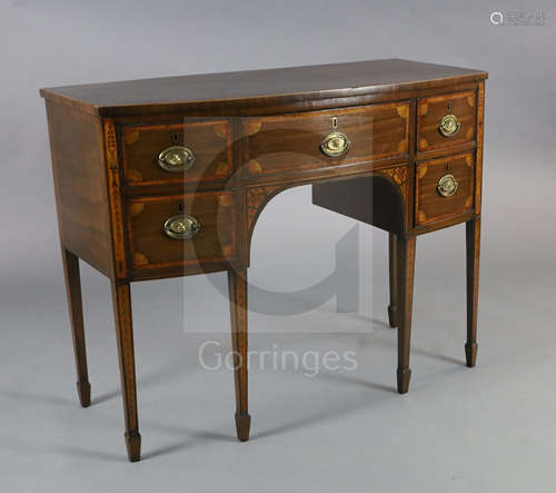 A George III inlaid mahogany bowfront sideboard, fitted five drawers, on squared tapered legs with