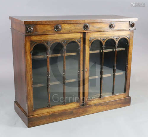 A William IV rosewood bookcase, with frieze drawer over two astragal glazed doors enclosing shelves,