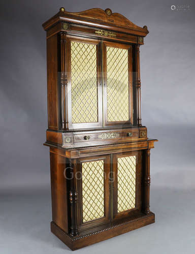 A Regency brass inset rosewood bookcase, with moulded pediment over two brass grille silk pleated