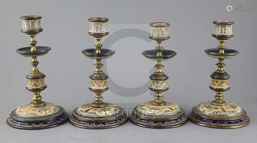 Frank A Butler for Doulton Lambeth, a set of four brass mounted candlesticks, c.1890, each incised