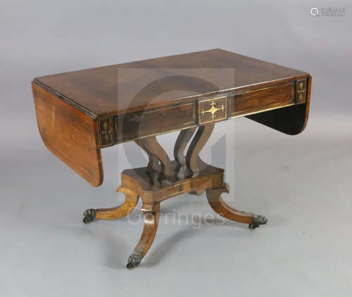 A Regency brass inset rosewood sofa table, with rounded rectangular flaps and two frieze drawers, on