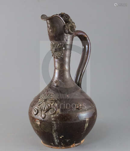 A Turkish Cannakale pottery ewer, 19th century, applied with medallions and scroll decoration and