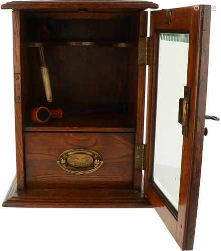 A wood pipe cabinet with facetted glass. 19th century.