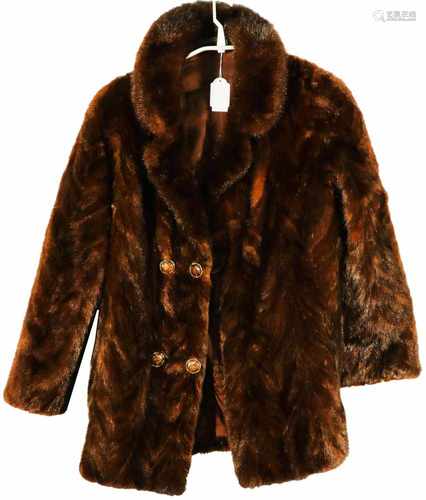 A furr coat with two rows of buttons at the front. 20th century.