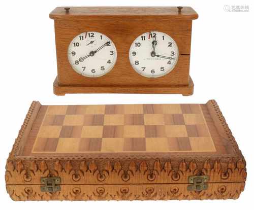 A lot with a chess set and a chess clock.