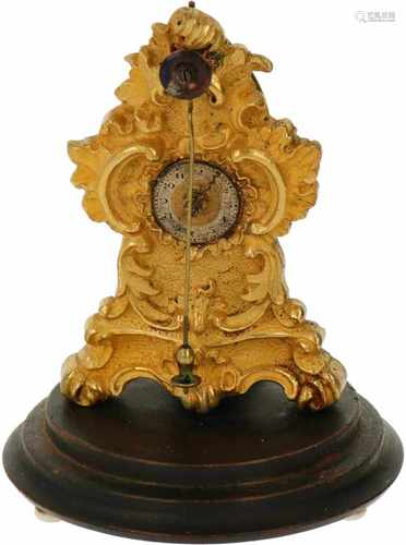 An ormolu miniature clock with bell jar. Ca. 1900.