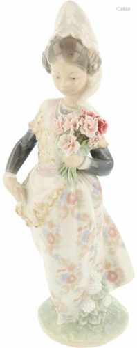 A Lladro figurine in the shape of a Spanish girl with flower basket. Marked underneath.