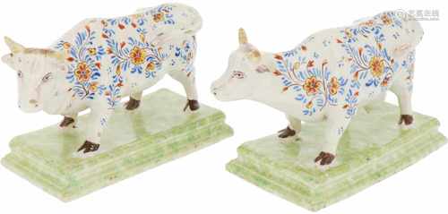 A set of polychromed cows, marked 