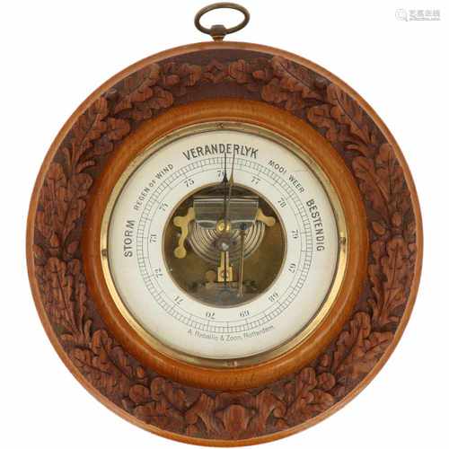 A round barometer with carvings and oak leaves. Adress: A. Reballio & Zoon, Rotterdam. Ca. 1930.