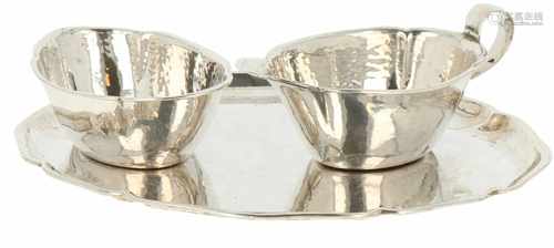 Silver set of creamers with stand.