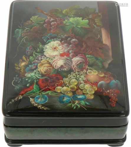 A Russian lacquer box with depition of a still life on a plinth.